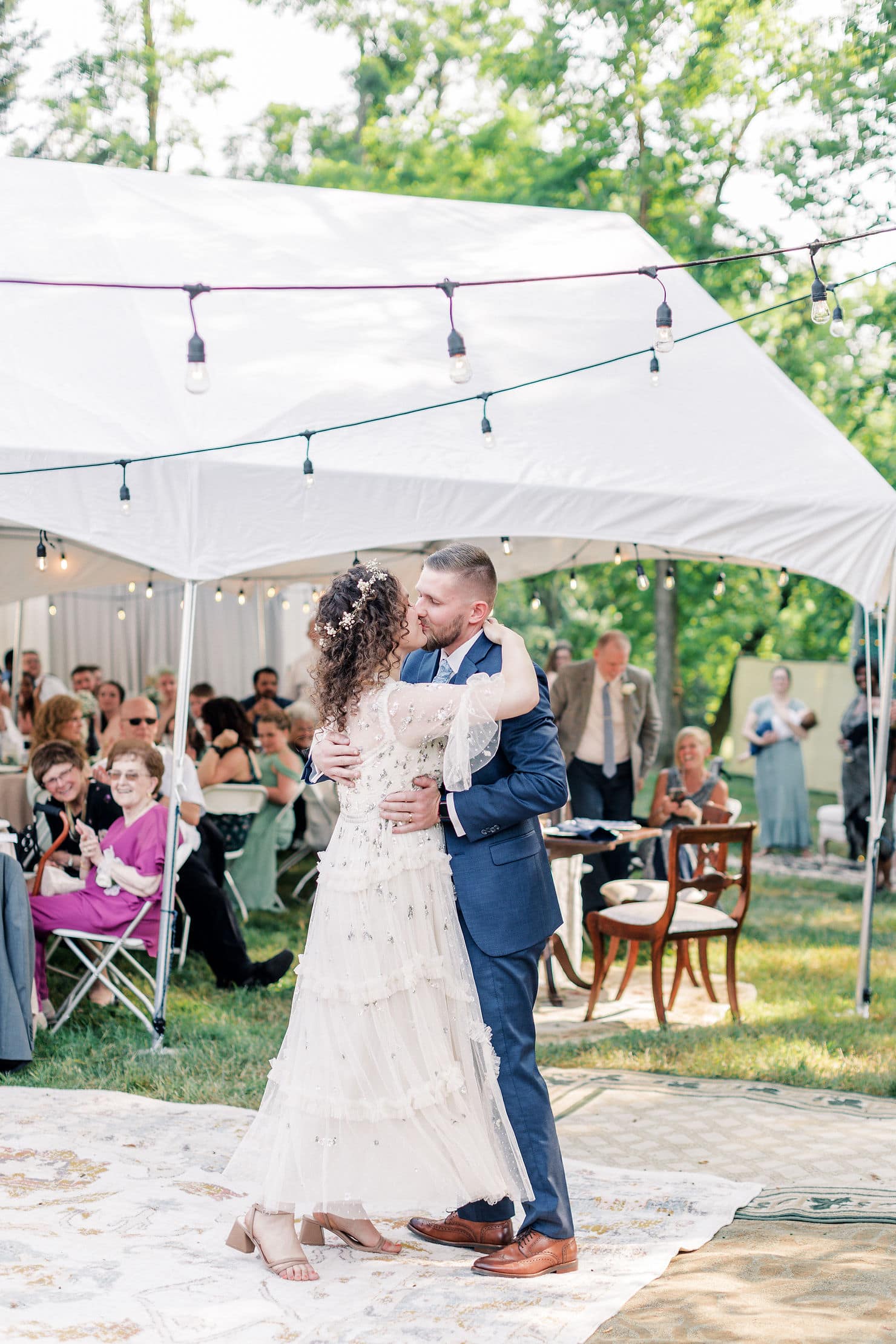 twinkle lights and tents and carpeted backyard for a backyard style wedding
