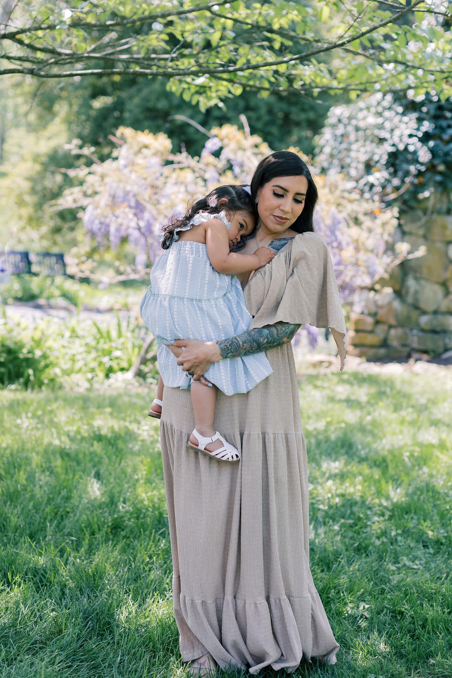 Elegant motherhood portrait featuring flowing dresses, soft greenery, and timeless spring florals in Morehead City, North Carolina.

