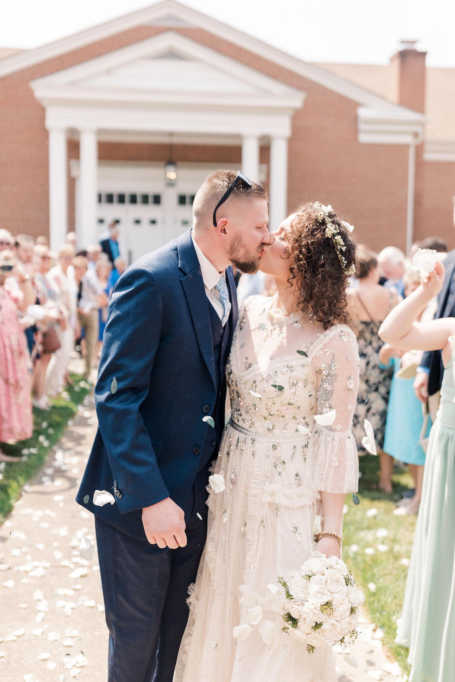 a wedding exit with a flower petal toss by guests