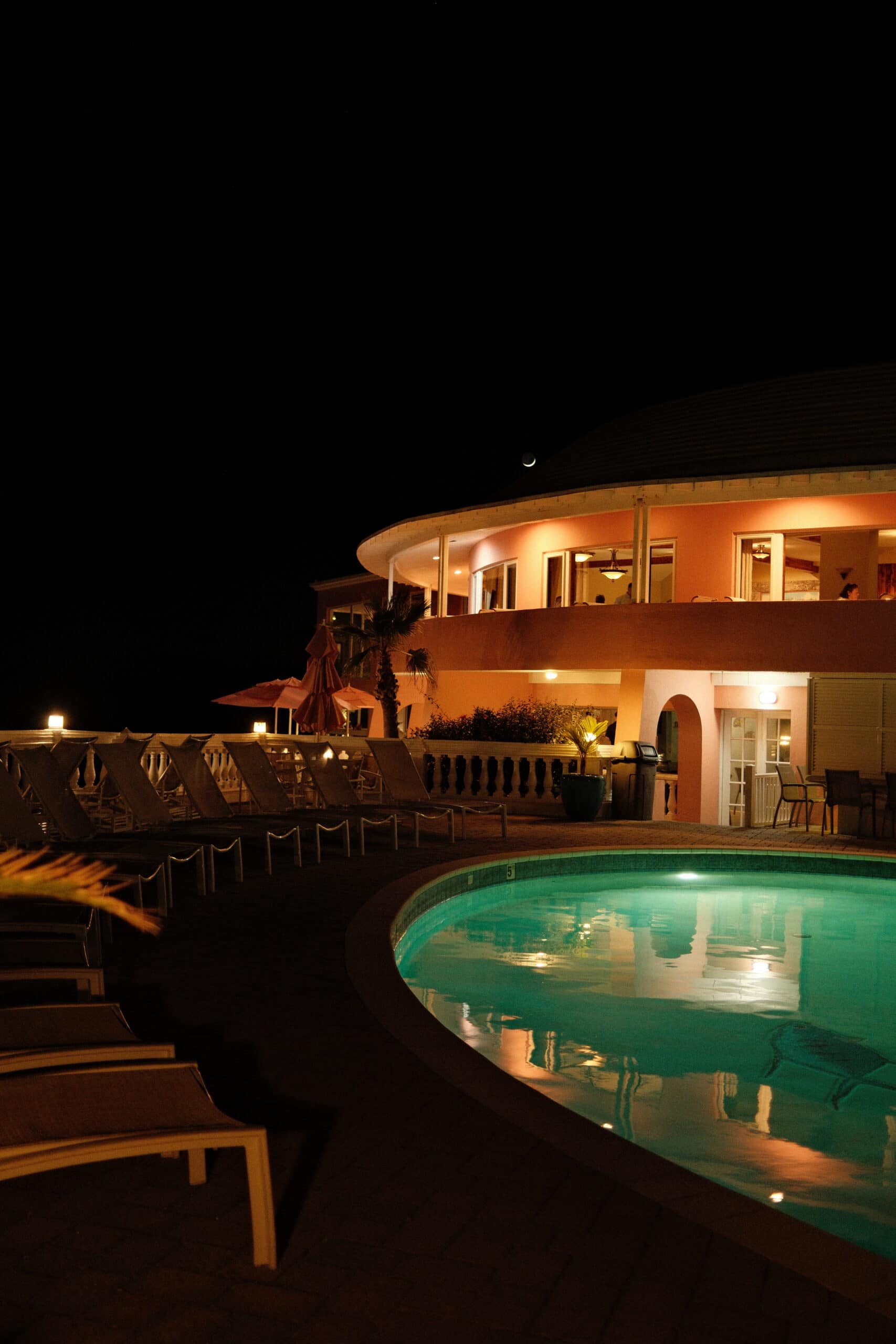 Pompano Beach club at night with the moon overlooking the hot tub and pool.