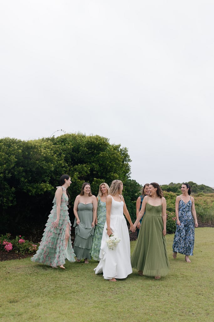 A bride and bridesmaids laugh before the ceremony at the Dunes Club in Atantic Beach