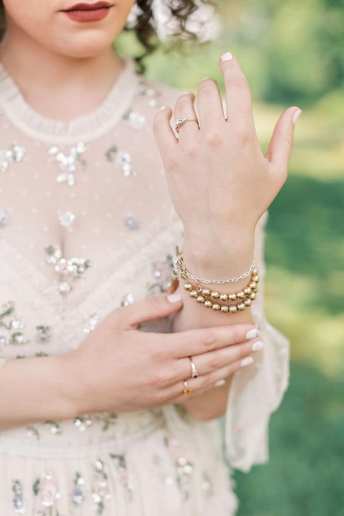 bridal details with gold jewelry and dress from needle and thread