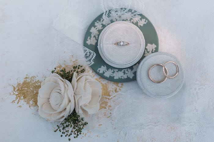 wedding details with wedding rings and flowers