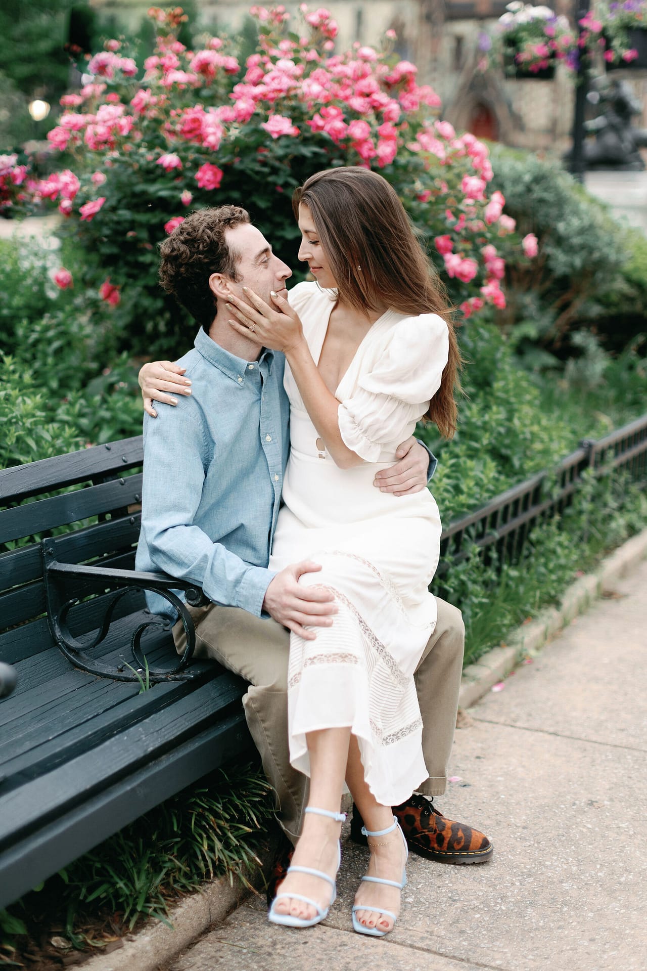 Candid engagement photo, playful laughter, charming neighborhood, joyous couple, Mt. Vernon Baltimore, urban love