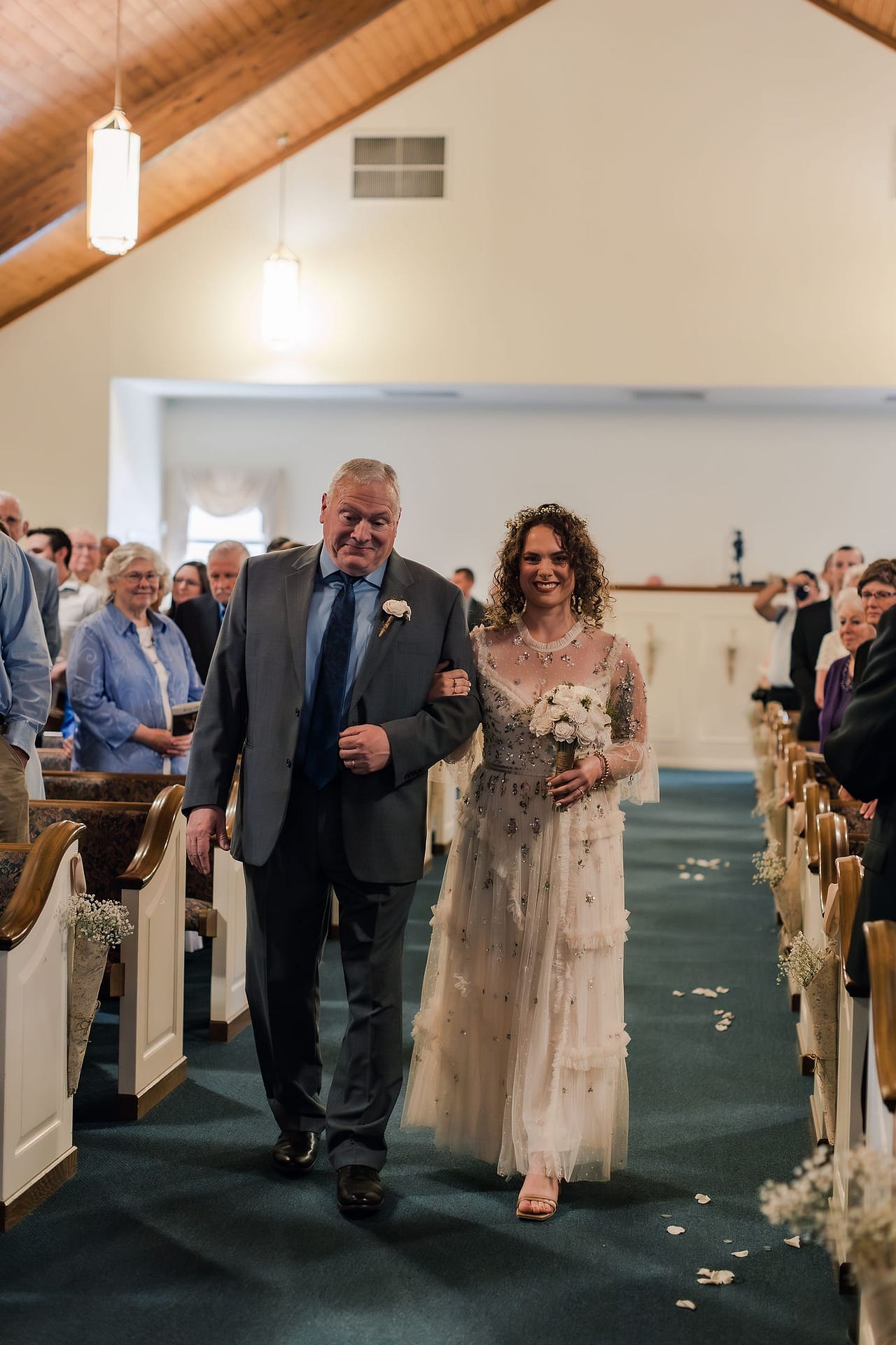 a bride walking down the aisle at liberty Presbyterian church in carroll county maryland
