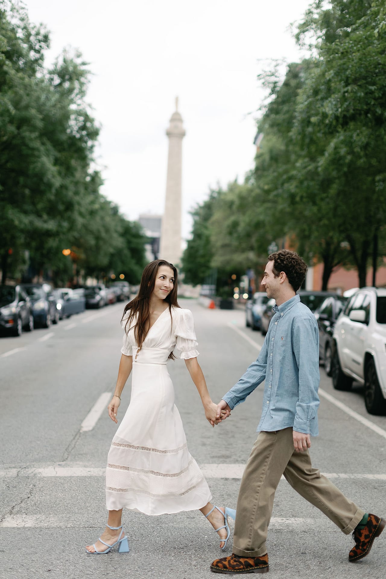 Washington Monument proposal, iconic landmark, romantic embrace, Baltimore engagement photography, love in the city, heartfelt moment
