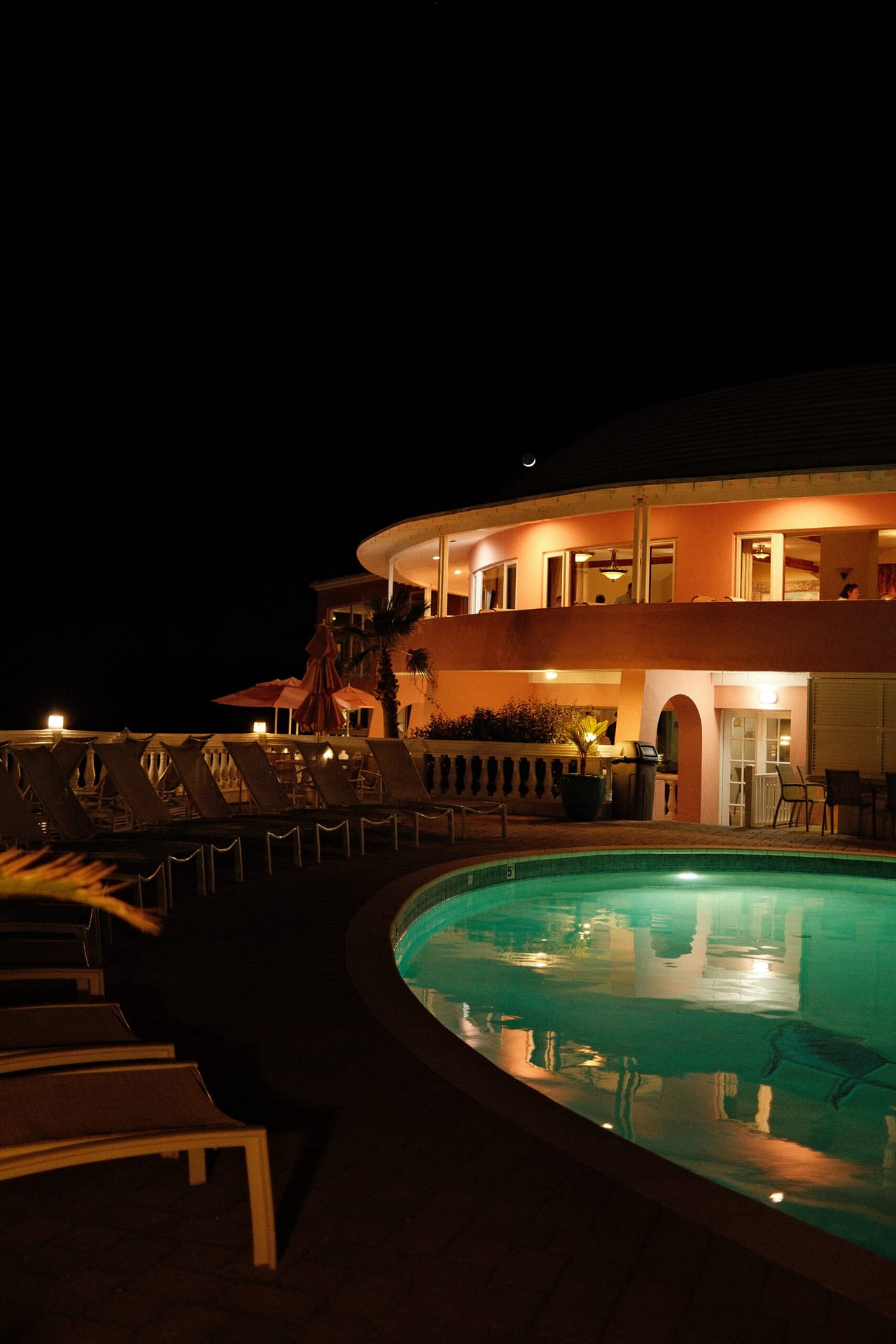 Pompano Beach club at night with the moon overlooking the hot tub and pool.