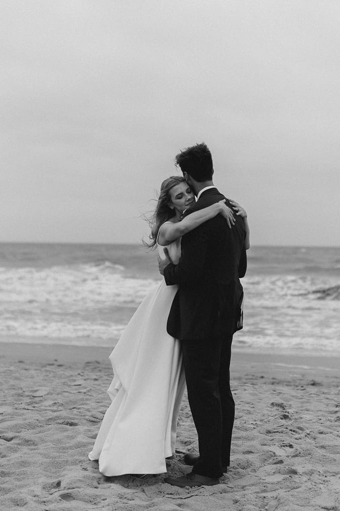 A bride and groom slow dance on the outer banks during their private beach ceremony