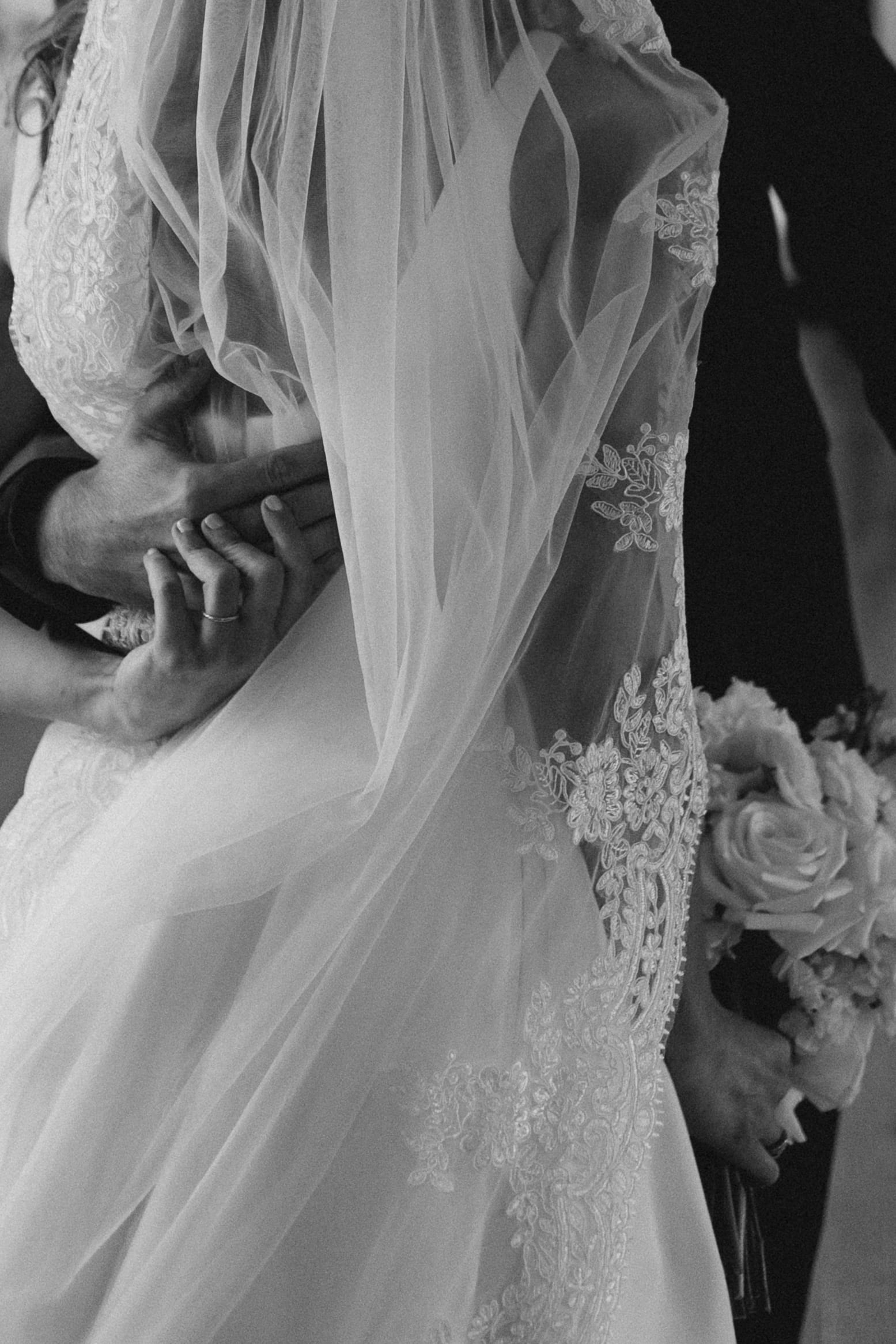 Close-up of lace veil and bouquet in black and white at The Dunes Club, Atlantic Beach.Close-up of lace veil and bouquet in black and white at The Dunes Club, Atlantic Beach.